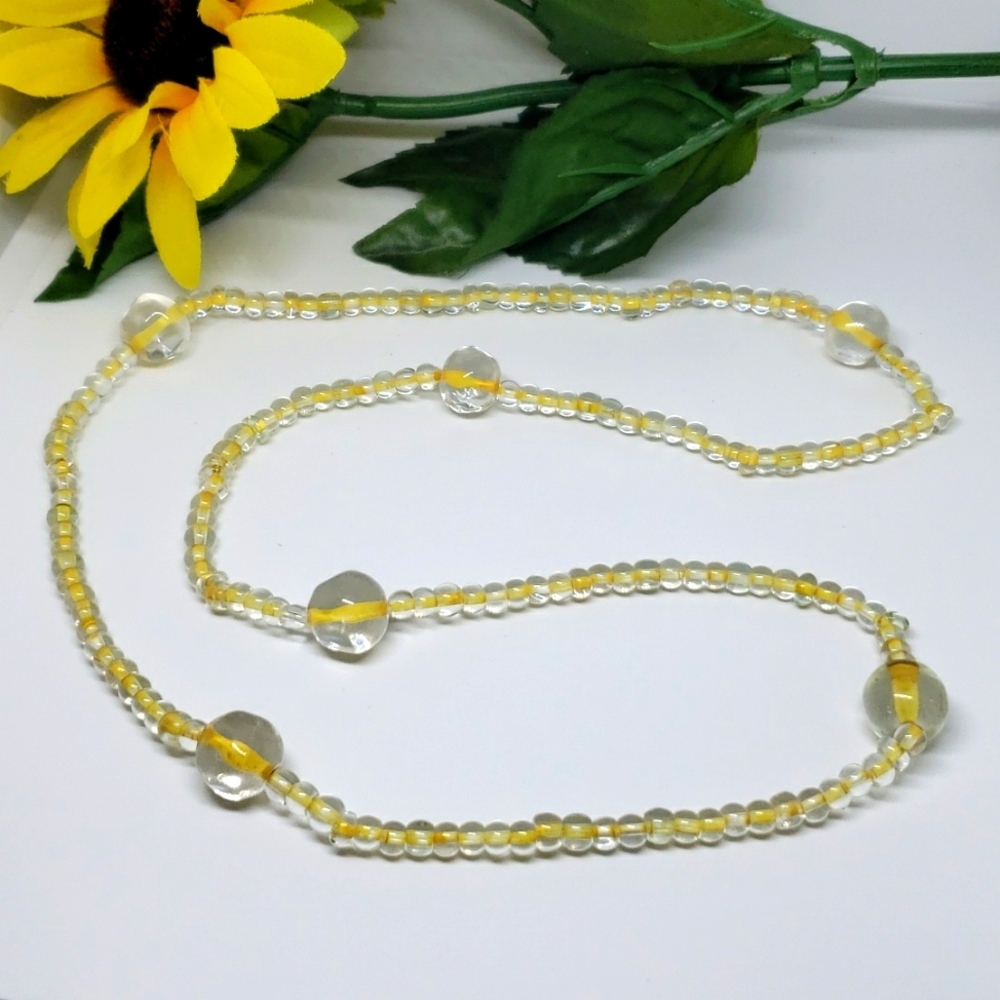 Clear beaded necklace on yellow strand 28"